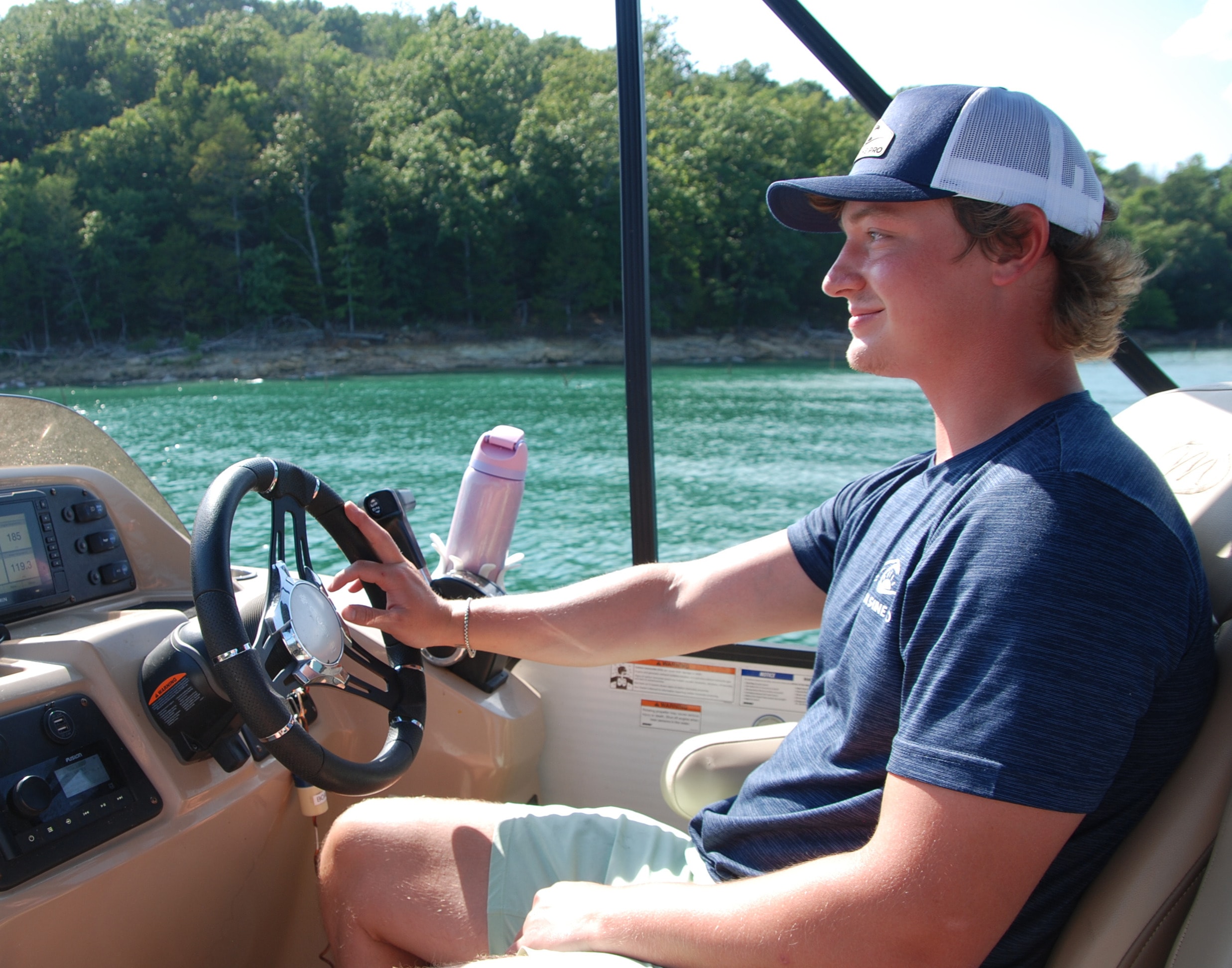 Matthew Lester, founder of Aqua Shine Pro, at the helm on the lake