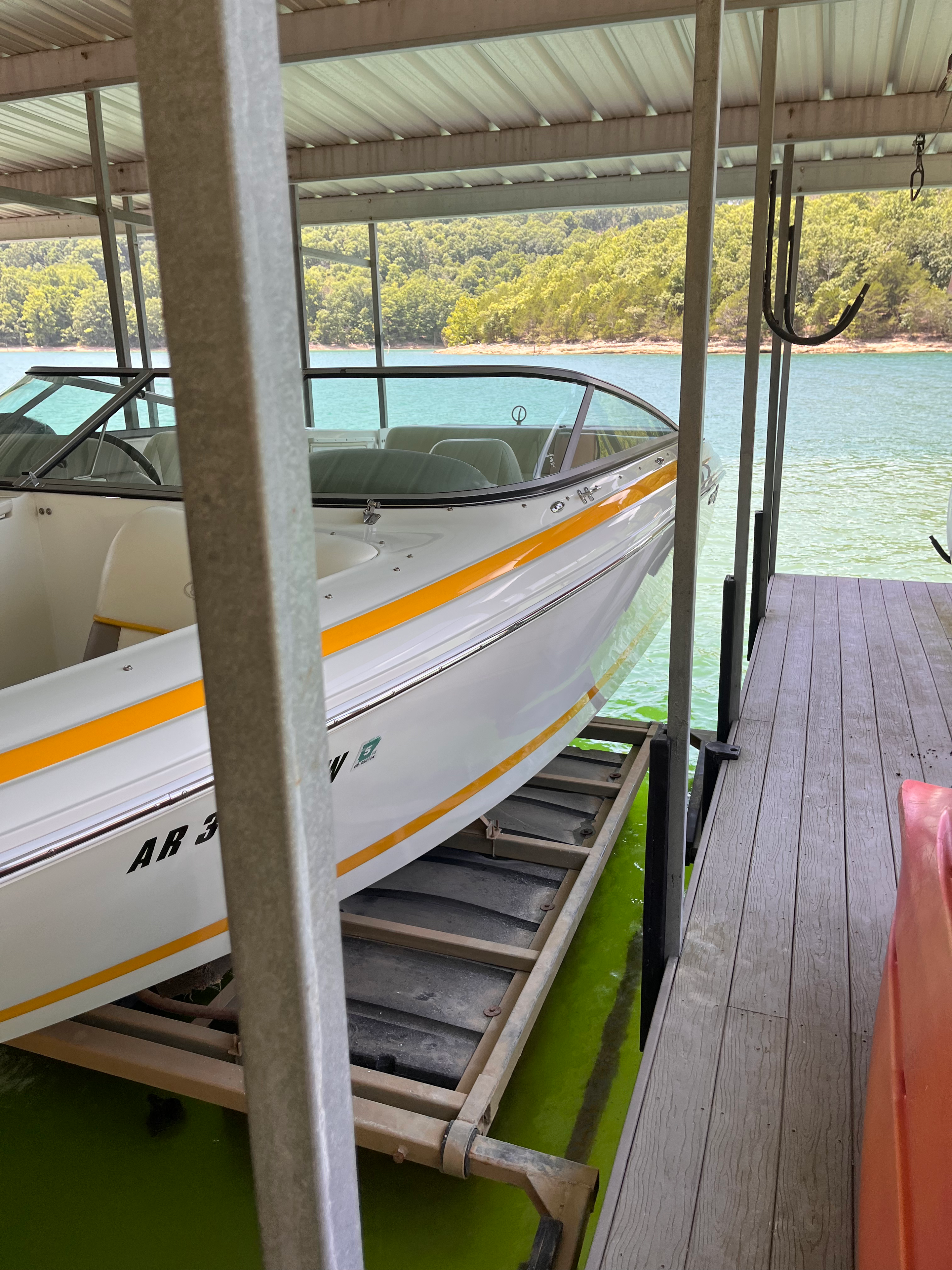 White and orange boat on lift